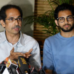 Shiv Sena chief Uddhav Thackeray addresses a press conference as his son Aaditya Thackeray looks on, in Mumbai on Tuesday