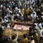 'Not easy to lift two coffins': Pakistan buries dead from massive suicide attack at political rally