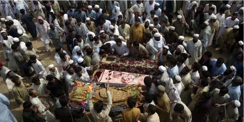 'Not easy to lift two coffins': Pakistan buries dead from massive suicide attack at political rally